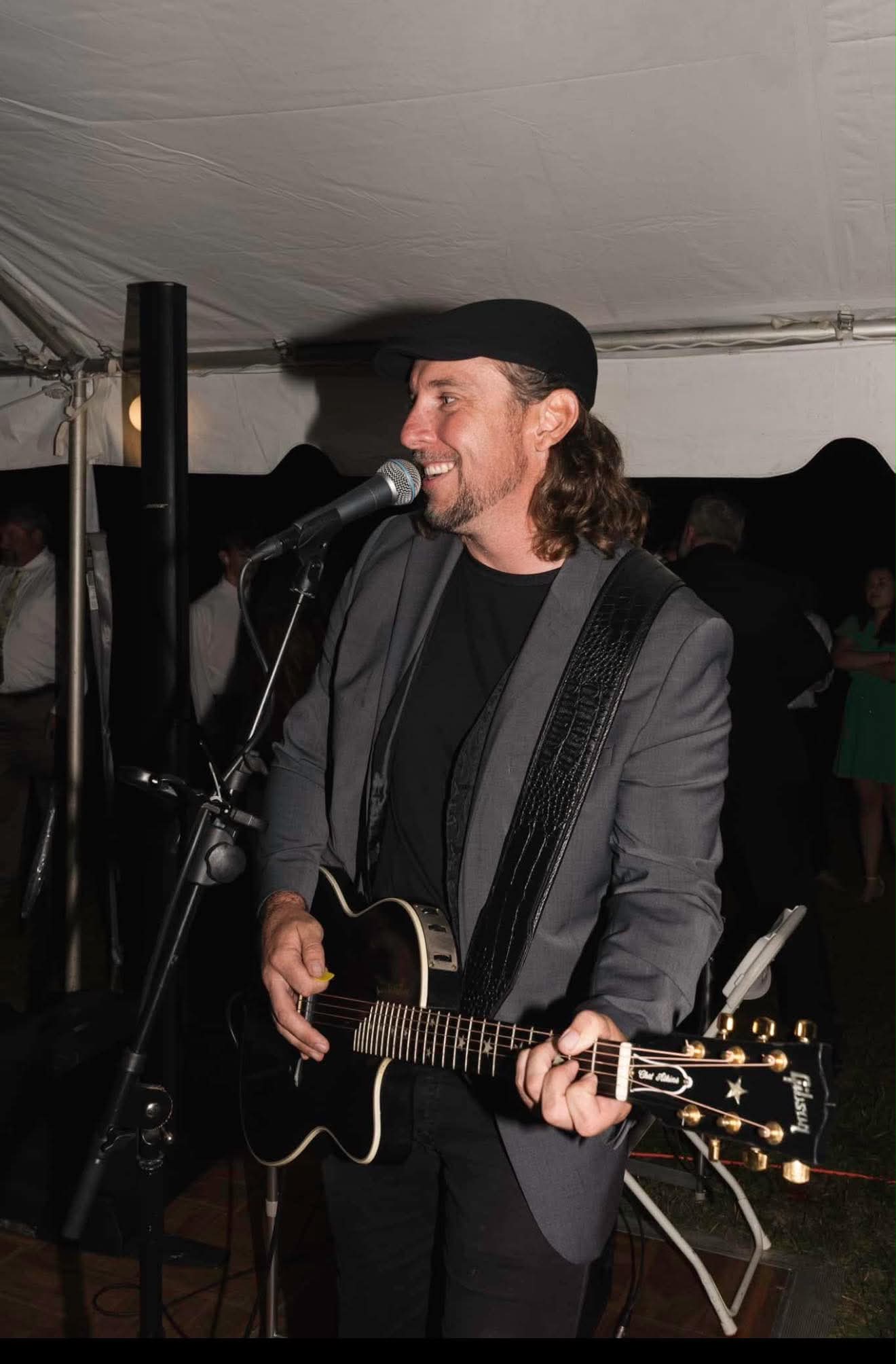 Josh singing and playing acoustic guitar