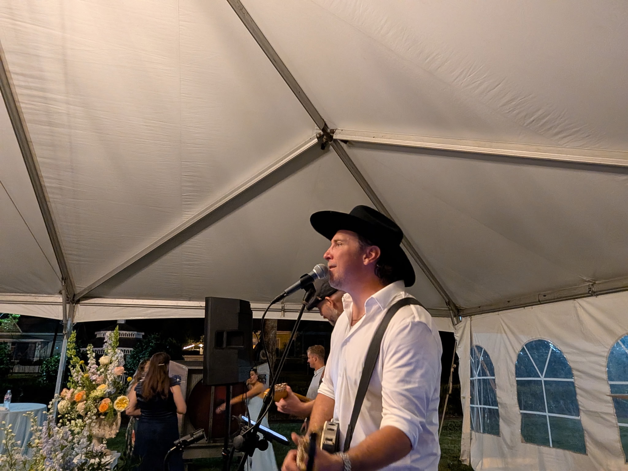 Josh performing under an event tent